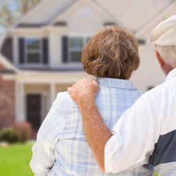 An older New England couple looks at their home while weighing whether a loan modification can stop the foreclosure sale."